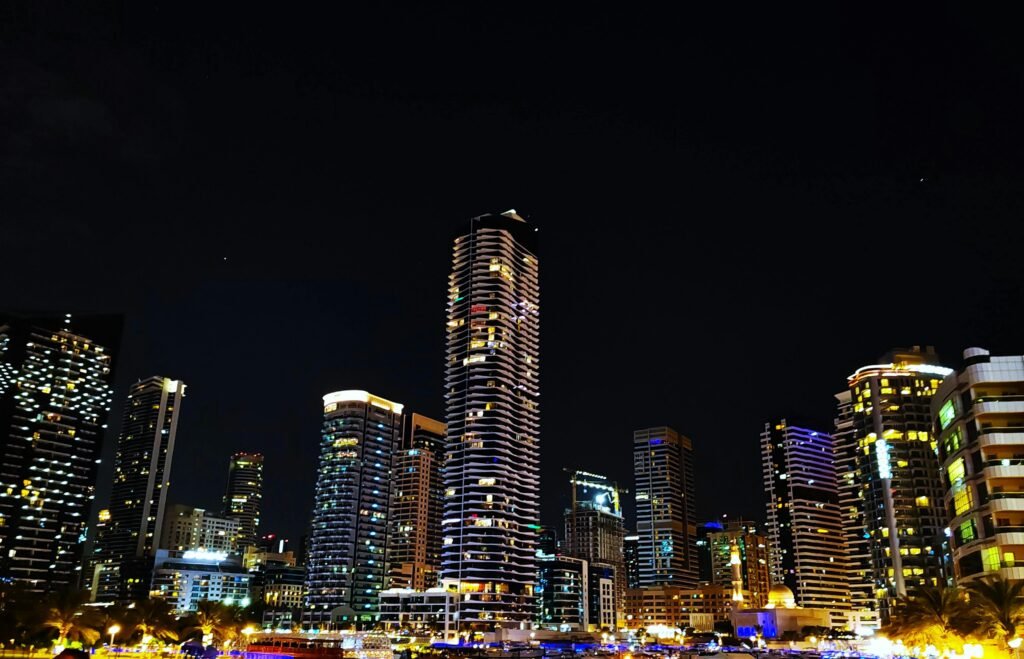 pexels-photo-30063501-30063501 Stunning night view of the Dubai Marina skyline with illuminated skyscrapers reflecting urban vibrancy.