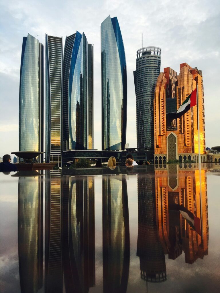Stunning view of Abu Dhabi's skyline with modern skyscrapers reflecting beautifully at twilight.
